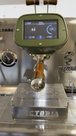 Close-up of an espresso machine's control panel.