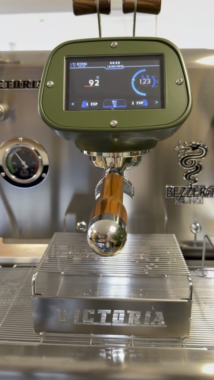 Close-up of an espresso machine's control panel.