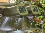 Modern green espresso machine with digital displays.