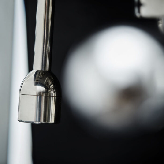 Close-up of a metallic kitchen tap spout