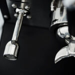 Close-up of a shiny espresso machine component.