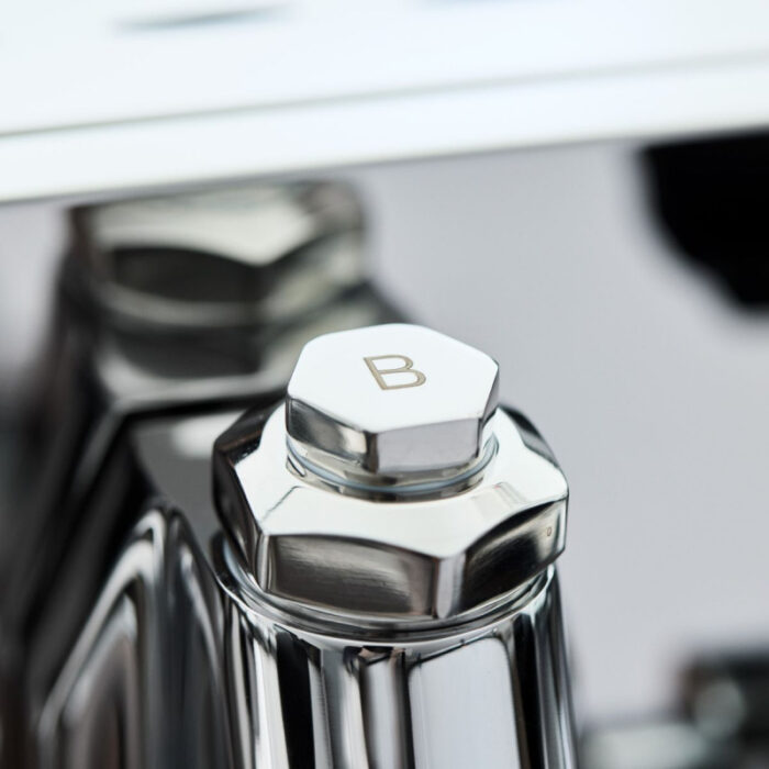 Close-up of a chrome hexagonal knob marked 'B'.
