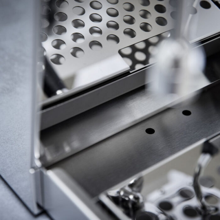 Close-up of a metallic grater surface.