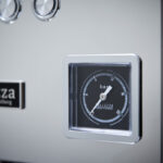 Close-up of a pressure gauge on coffee machine.