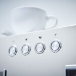 Close-up of an espresso machine control panel.