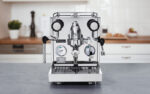 Polished espresso machine with gauges and levers.