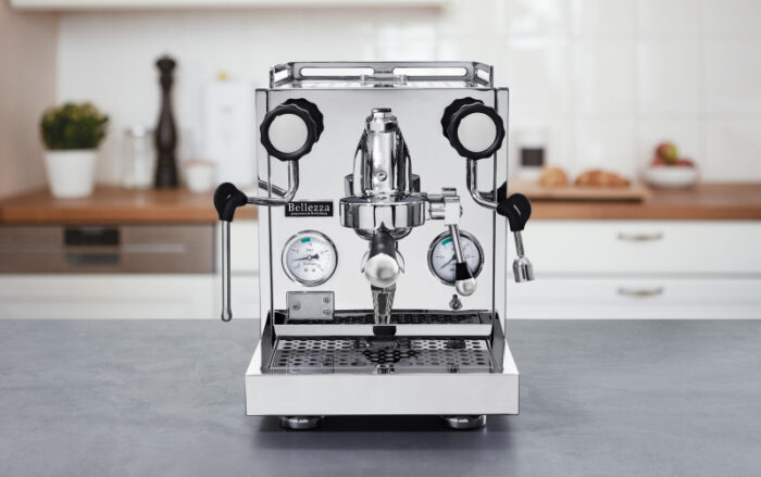 Polished espresso machine with gauges and levers.