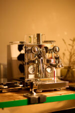 Shiny espresso machine on a wooden table