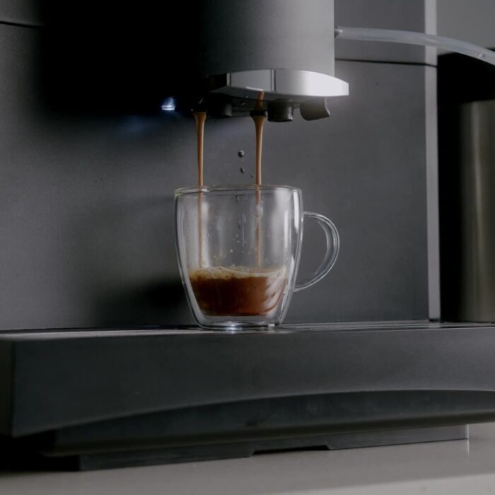 Espresso pouring from the Bestir BM40 Pro into a glass cup