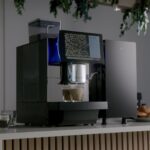 Coffee pouring from the Bestir BM80 with the bean hopper visible