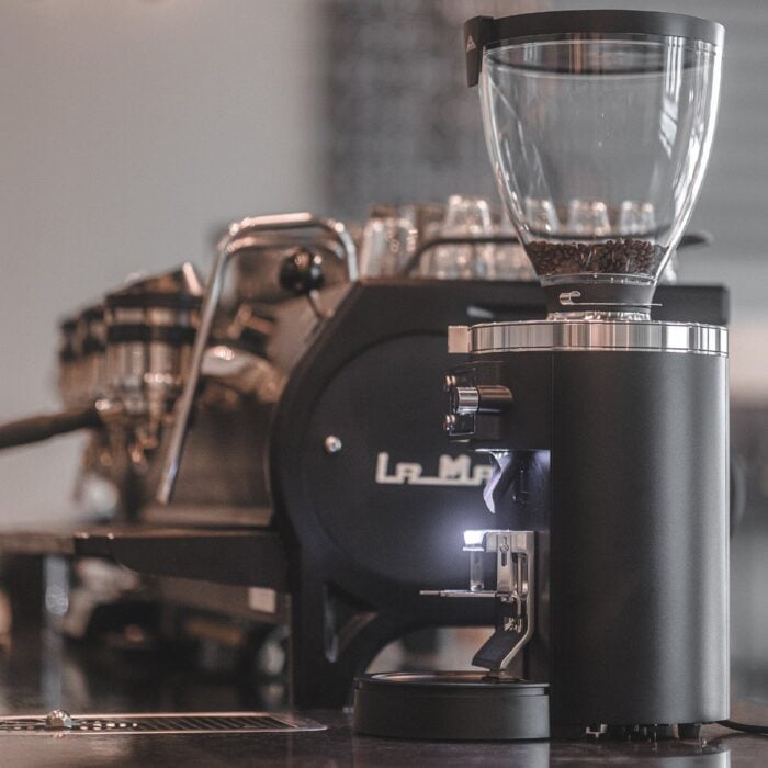 Mahlkönig E80 Supreme GbW coffee grinder in use on a coffee bar