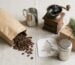 Coffee gift flat lay with a bag of beans, hand grinder, milk jug, chocolate shaker and Christmas tree stencil